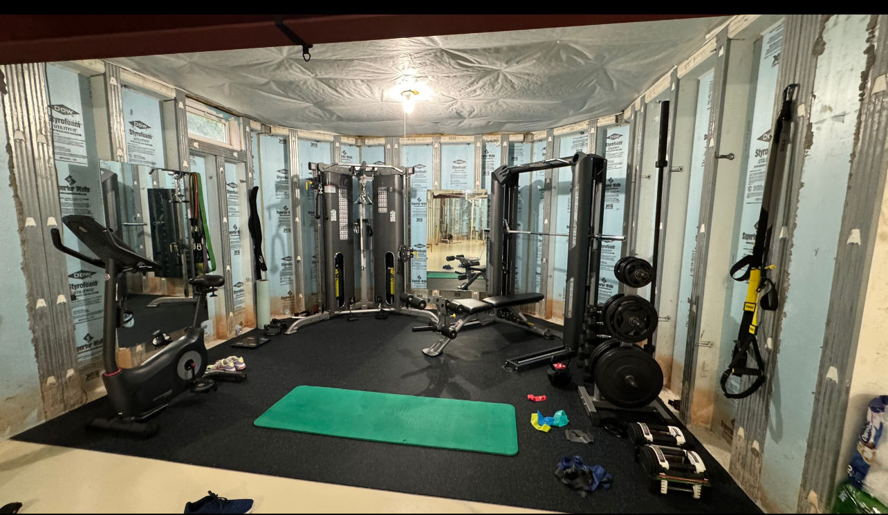 Two men assembling wooden wardrobe, wearing safety vests. Expert Furniture Assembly in Central NJ.