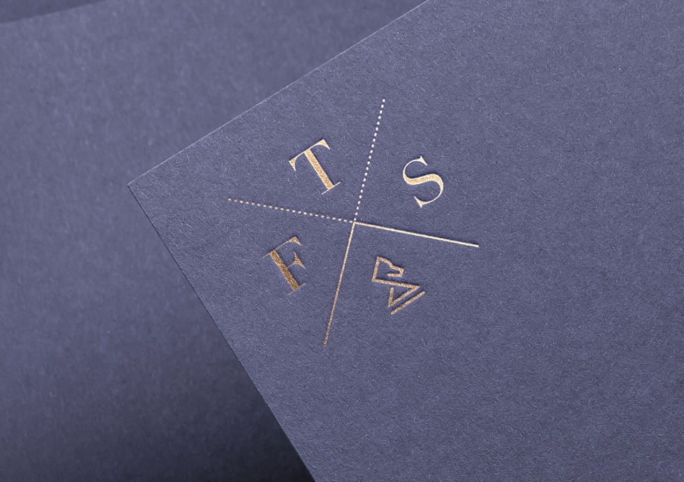 gold FTS Logo Design on blue paper