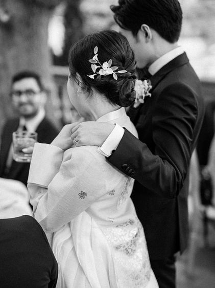 A candid moment of a couple holding hands at their wedding in Toronto, Ontario