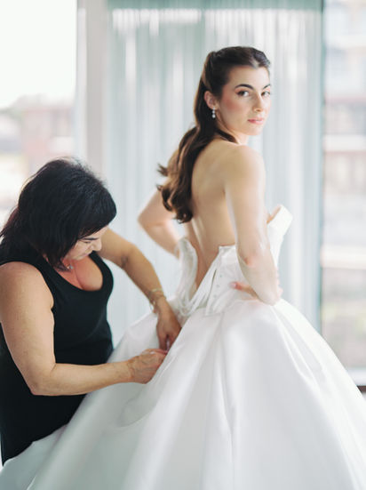 A bride getting ready at an Elora Mill Wedding, photographed candidly and edited light & airy