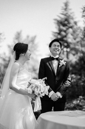 A couple laughing during their wedding ceremony in Toronto, photographed documentary-style.