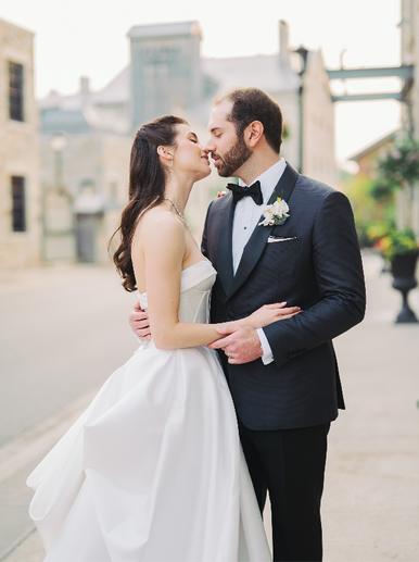 A couple kisses on their wedding day at Elora Mill