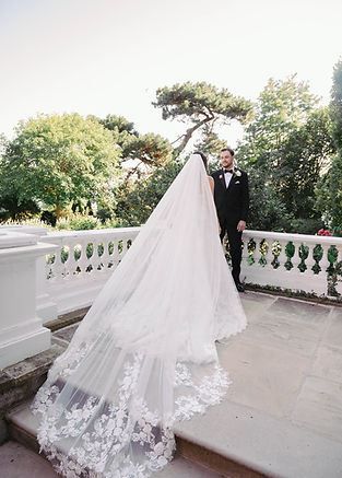 A bride with a long veil walks during her wedding in Oakville Ontario, edited with film