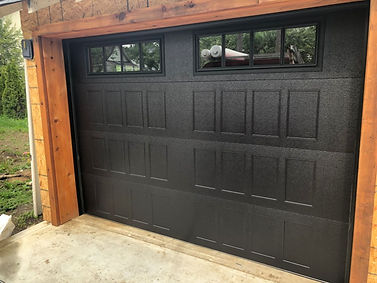 Black recessed panel garage door installed in Orangeville