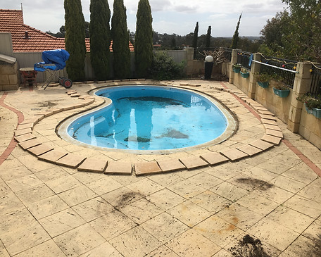 old broken paving around pool