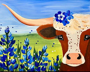cow on a field with blue bonnet flowers