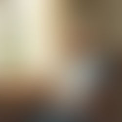 Caregiver sitting peacefully with tea by window, taking essential respite break during demanding holiday season while caring for brain injury survivor