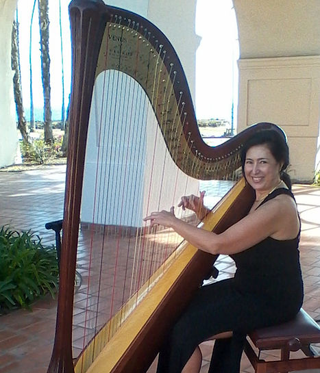 Harpist Valérie Saint Martin performing at a wedding at the Hilton Santa Barbara Beachfront Resort.