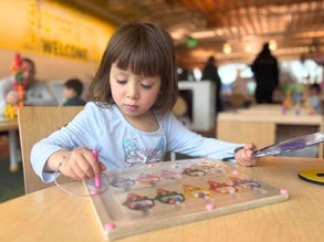 Preschool child doing hands-on learning activity at daycare center