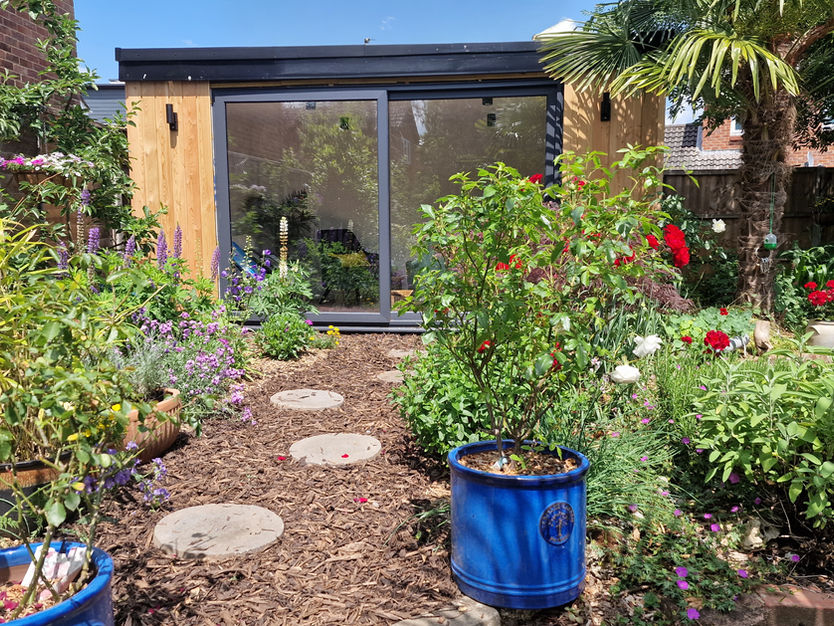 Bespoke therapy garden room office. Featuring larch cladding and large graohite UPVC sliding door