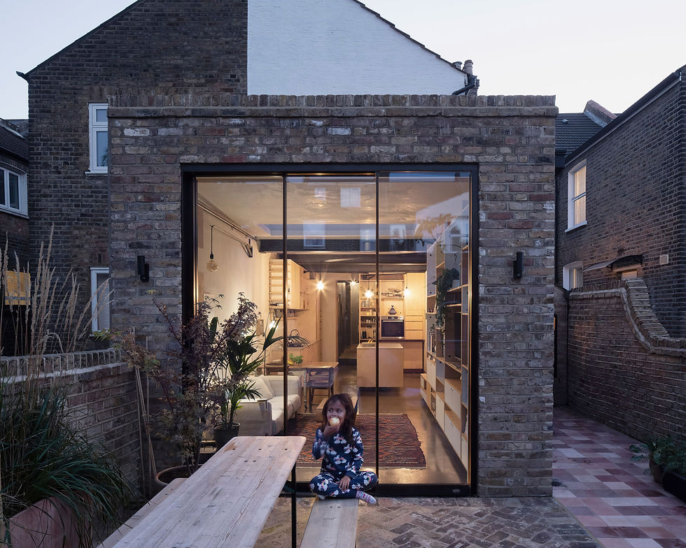 girl-sits-deck-outside-house-that-has-glass-door-that-says-word-it.jpg