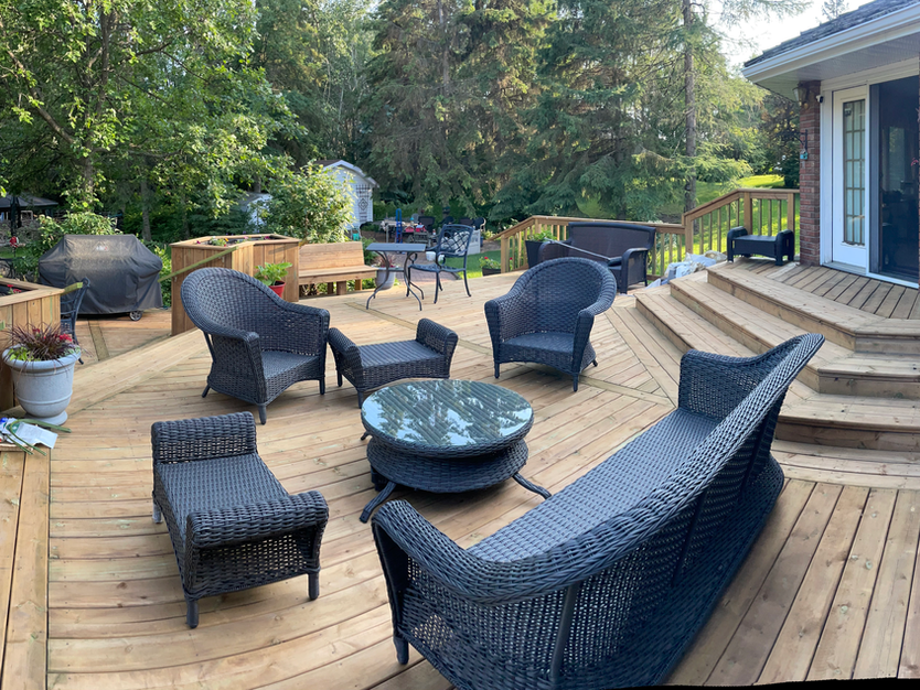 New deck with beautiful plants and flowers surrounding the deck.