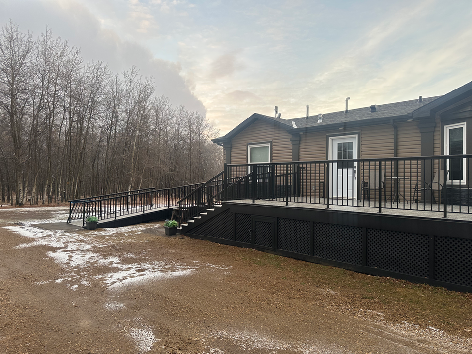 Mobility friendly deck for a modular home on a sprawling acreage.
