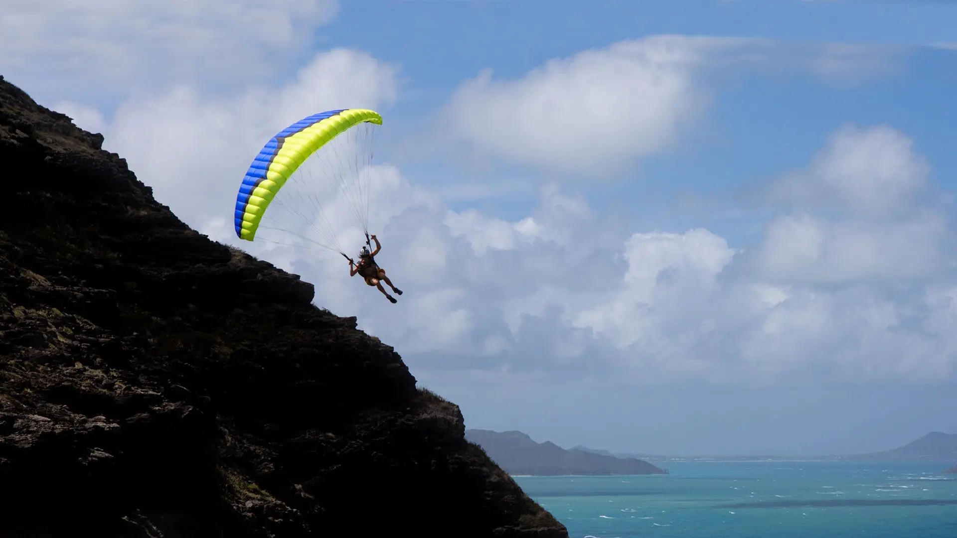 Speed flyer soaring on a coastal cliff