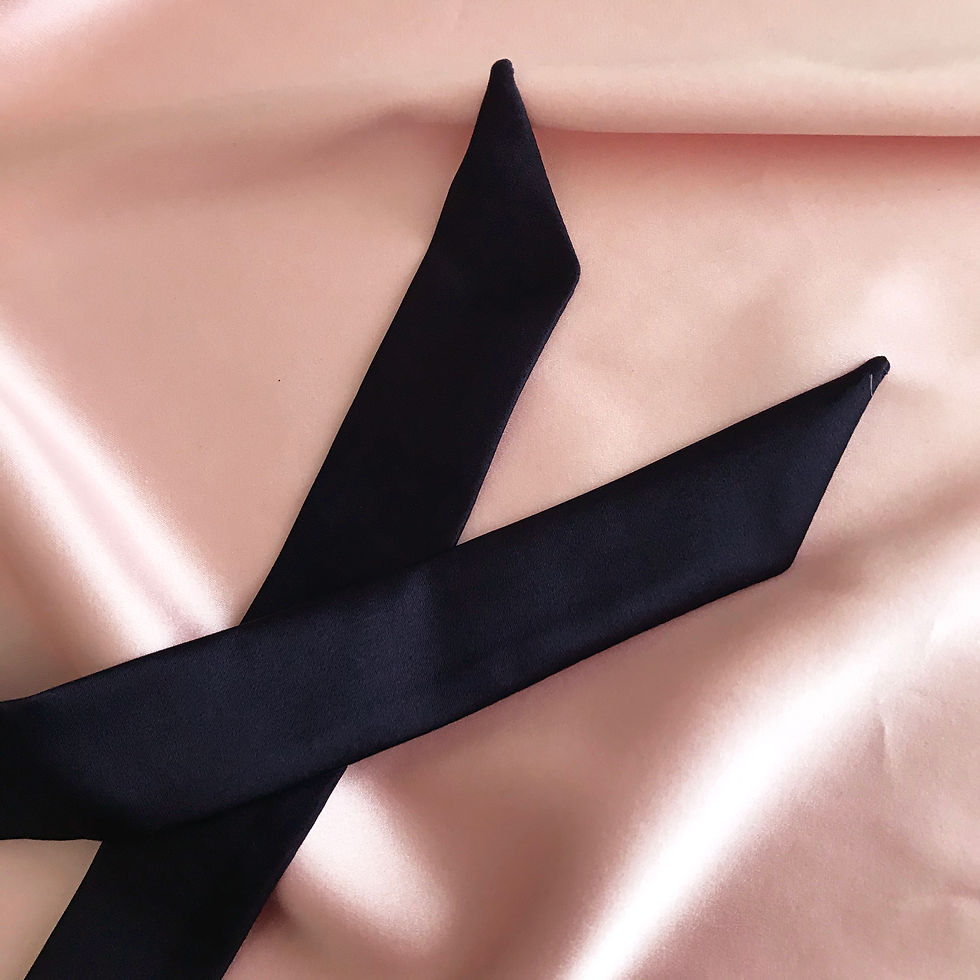 Thumbnail: The ends of a dark navy blue silk ribbon