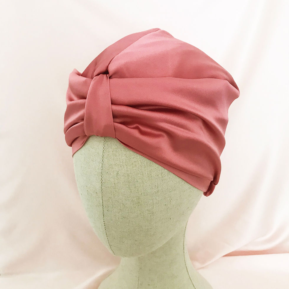 Thumbnail: A mid pink silk hair wrap on a mannequin head against a pale pink silk background