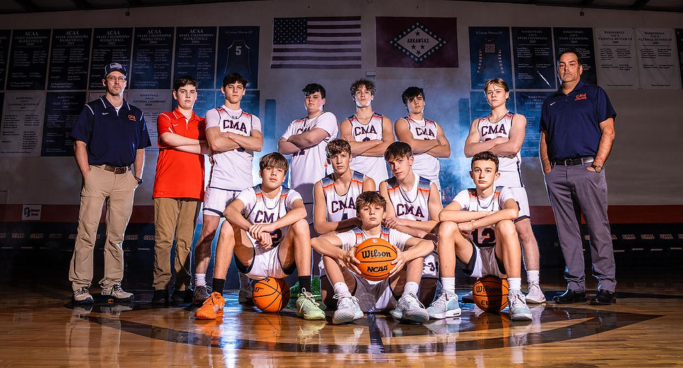 CMA Athletics basketball team posing in the gym.