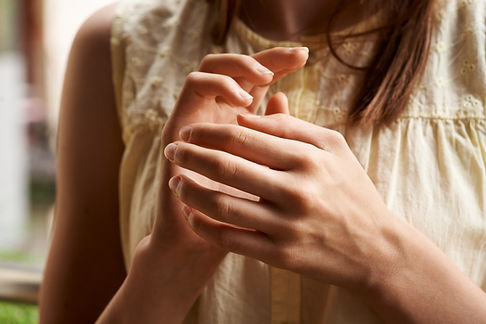 Hands of a girl practicing EFT or emotional freedom technique - tapping on the karate chop