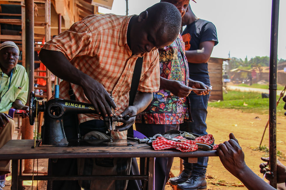 A man using a tool to service a sewing machine.