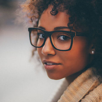 black-girl-closeup-wooden-sunglasses-curly-hair-look-back.jpg
