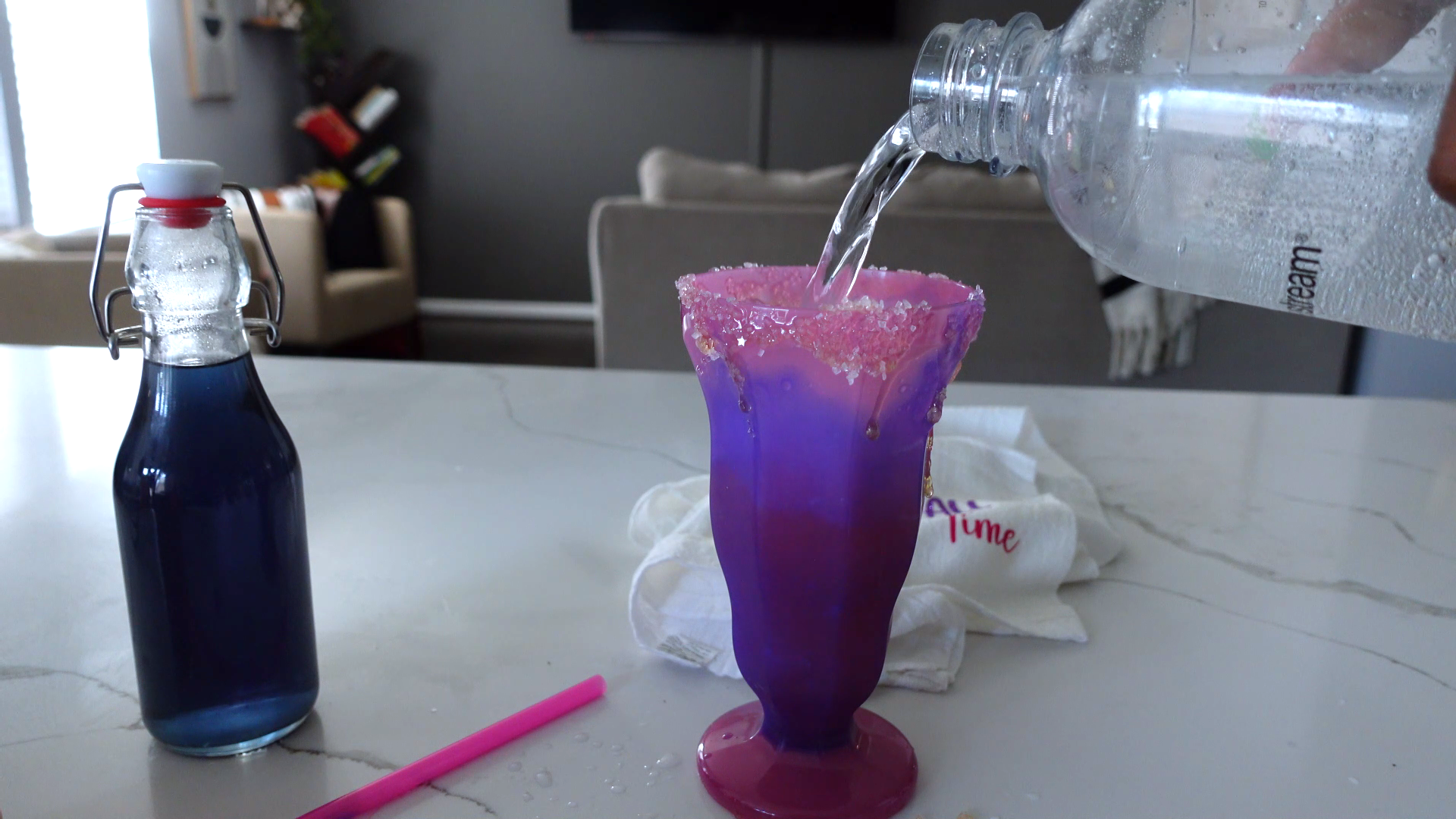 soda stream carbonated water being poured into glass 