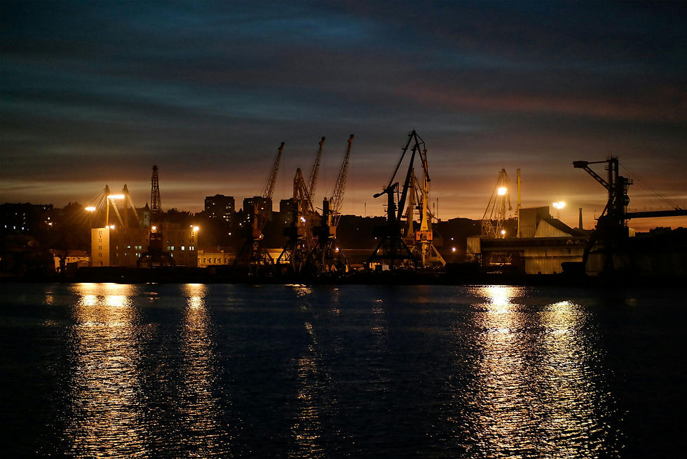 Eye-level view of automated crane system lifting bulk materials at a port