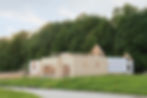 house being framed on grassy lot with trees