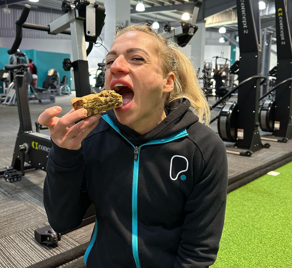 Young women eating mini egg protein cookie bar