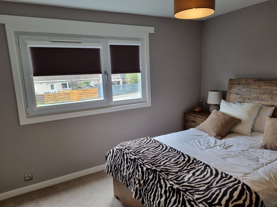 2 maroon perfect fit roller blinds fitted to 2 bedroom windows
