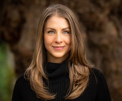 A close-up portrait of Cara, a BC therapist, wearing a black shirt.