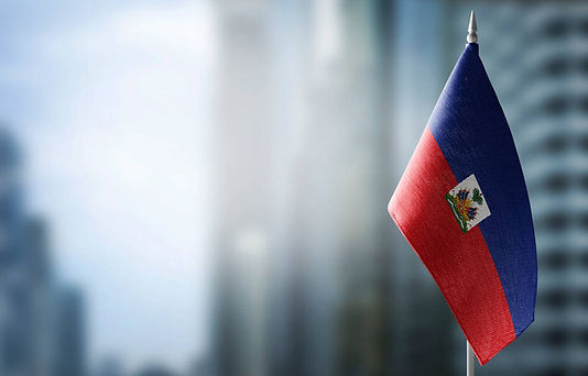 stock-photo-a-small-flag-of-haiti-on-the-background-of-a-blurred-background.jpg