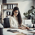 woman in a office working on a desk.jpg