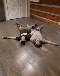 Couple relaxing on new hardwood floor