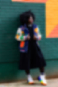 Tee is leaning against wall art in Leeds City Centre.