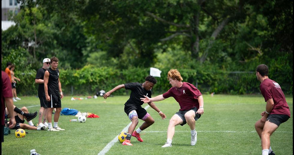 Eye-level view of a young soccer player practicing footwork drills on a grassy field