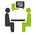 2 people talking at a table