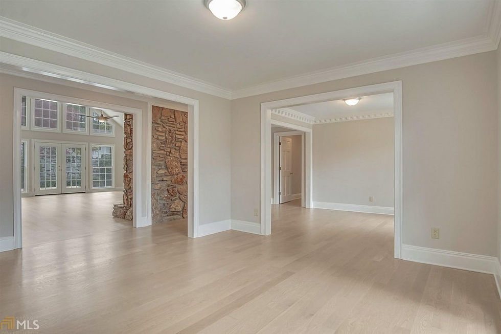 an empty room with a stone fireplace in the middle