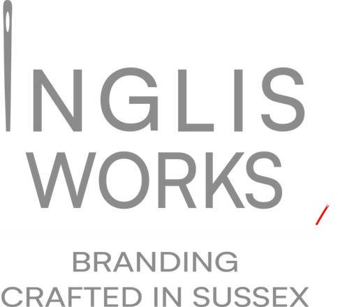 The Inglis Works main logo. It says "Inglis Works. Branding crafted in Sussex" The I in Inglis is an embroidery needle
