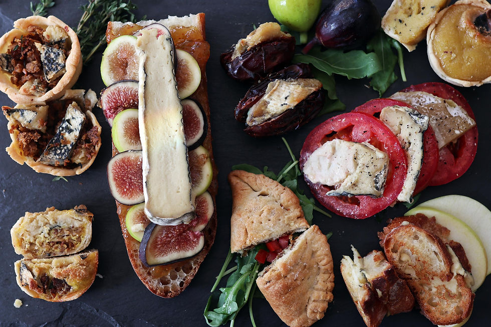 Vegan cambleu cheese on bread with figs and featured with tomato and some hors doerves