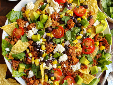 Tofu taco salad with avocado, tomato, black beans, corn, and queso fresco.