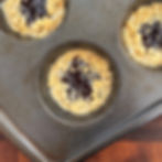 Tahini and jam crumble cookies in a muffin tin.