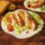 Fried green tomato snack wraps with shredded lettuce, bacon, and chipotle mayo.