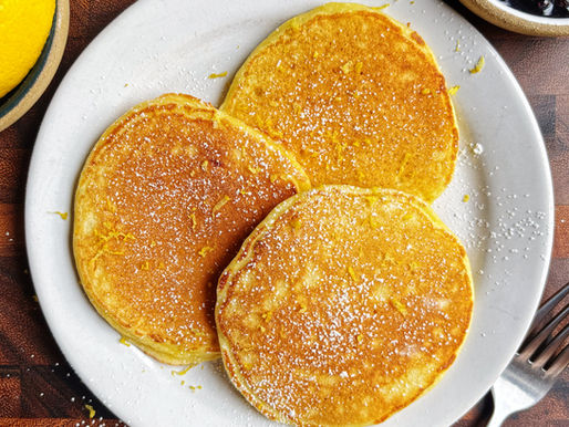 Cottage cheese pancakes dusted with powdered sugar and lemon zest.