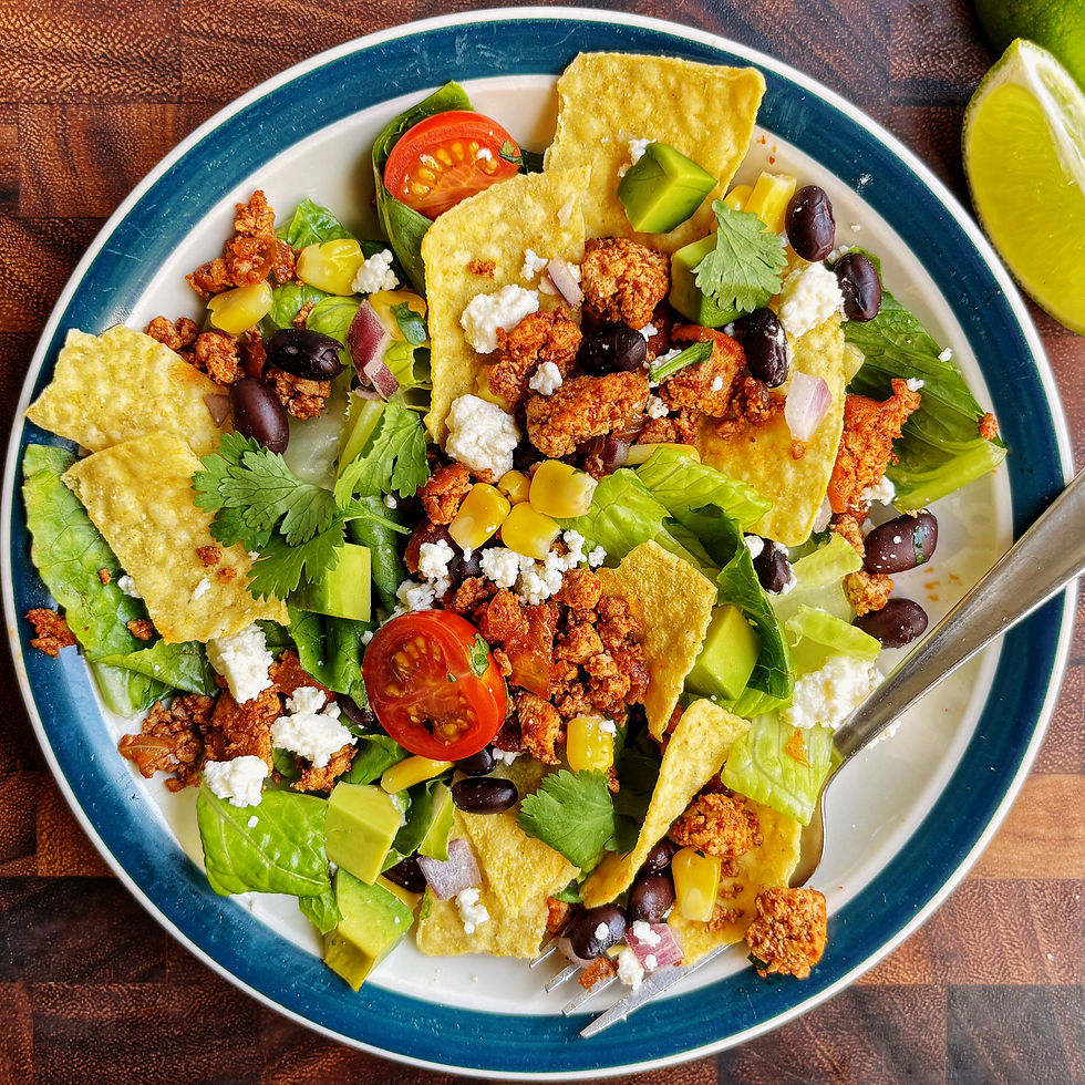 Tofu taco salad with avocado, tomato, black beans, corn, and queso fresco.
