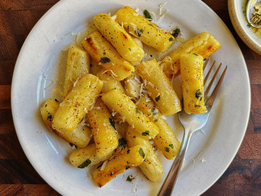 Crispy Korean rice cakes tossed in sage brown butter with parmesan on top.