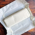 A block of crisco in its wrapper on a cutting board.