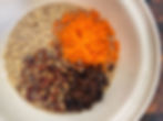 Baked oatmeal batter with shredded carrot, raisins, and pecans in a big bowl.