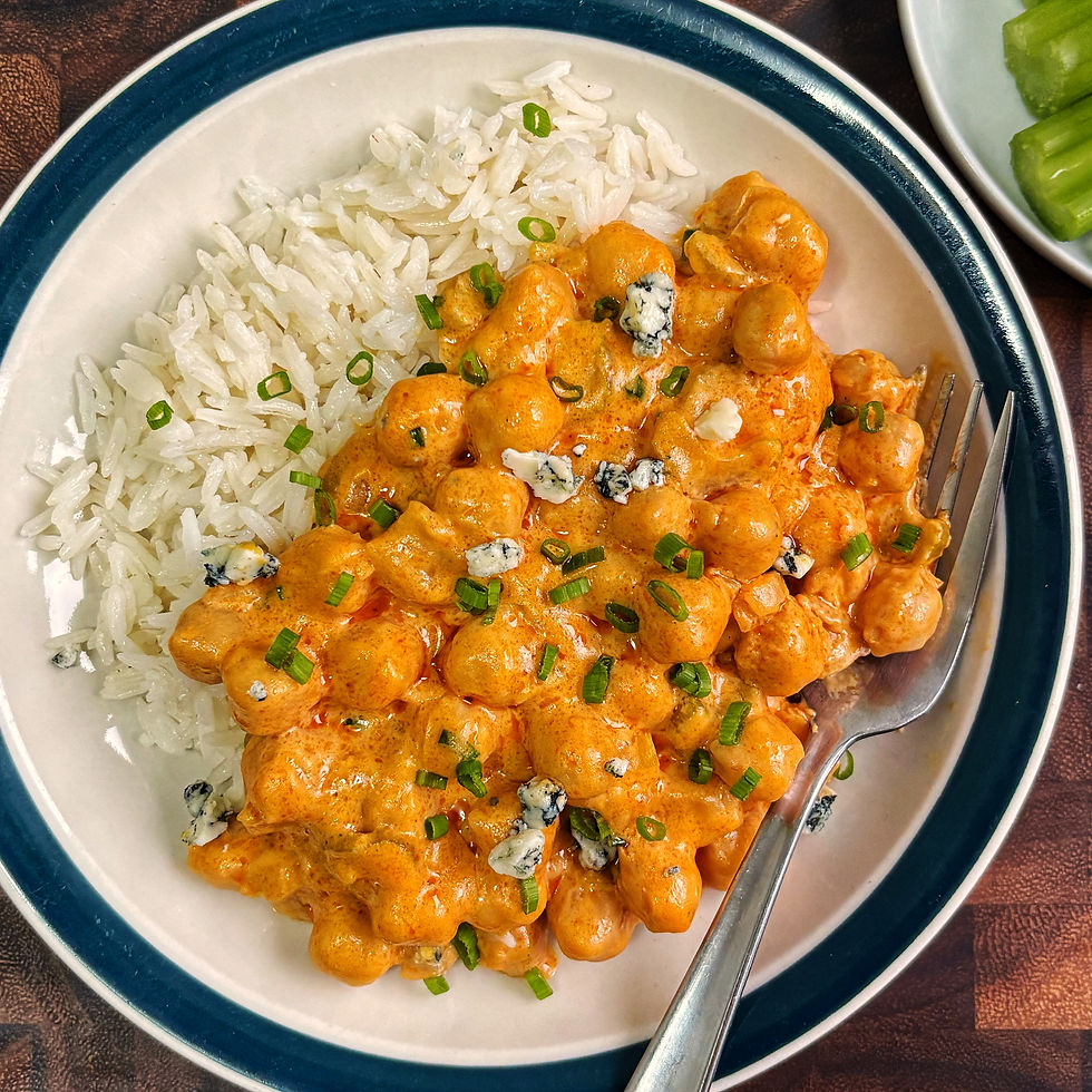 Buffalo chickpeas topped with blue cheese and chives over rice.