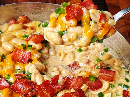 A spoonful of jalapeño popper white beans topped with crispy bacon and cheddar.