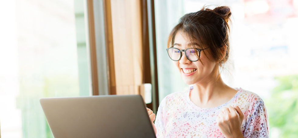 Girl looking at computer screen excitedly.